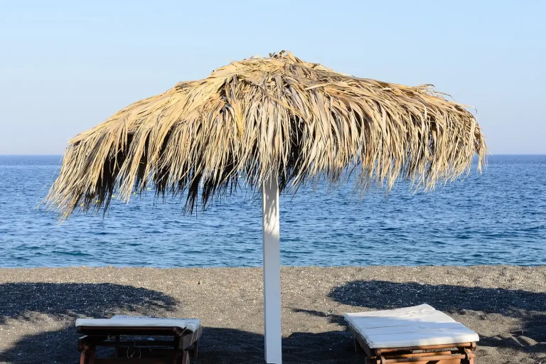 Black sand and clear water at Perissa beach in Santorini